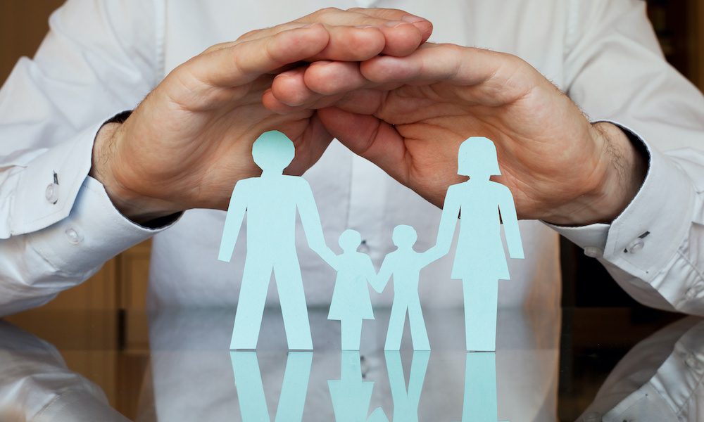 Group Health Insurance Explained - Group Health Insurance Hands Over A Family